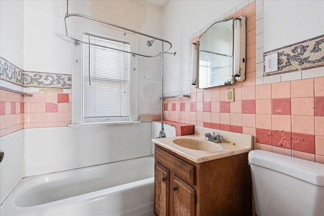 full bathroom featuring tile walls, vanity, toilet, and shower / bath combination