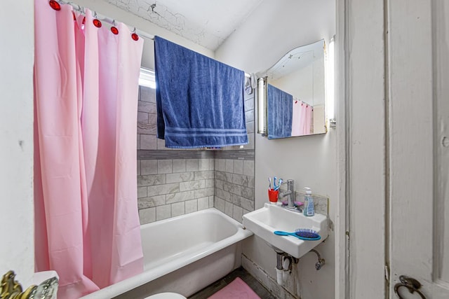 full bathroom featuring shower / bath combination with curtain, toilet, and sink