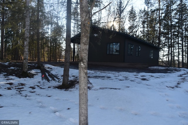 view of snowy exterior with a garage