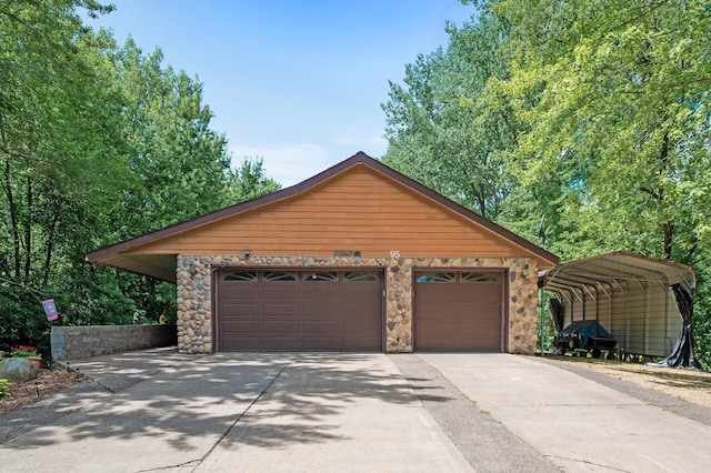 view of front of house featuring a garage, an outdoor structure, and a carport