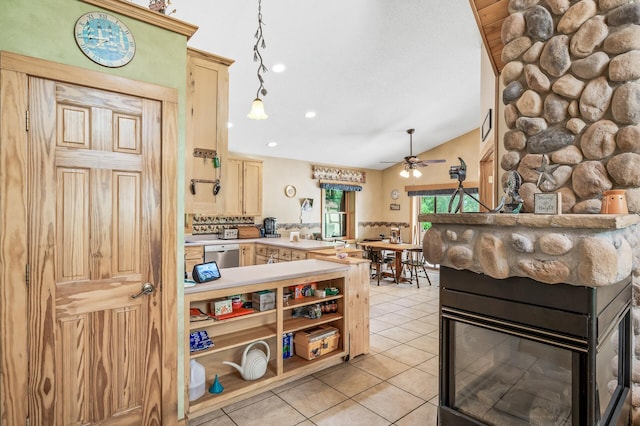 kitchen featuring light tile patterned floors, a fireplace, decorative light fixtures, vaulted ceiling, and stainless steel dishwasher