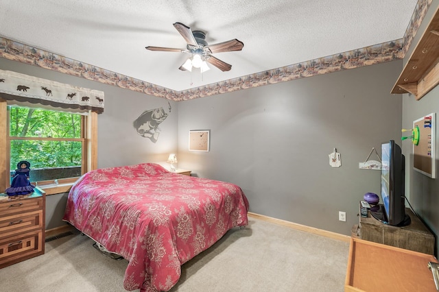 carpeted bedroom featuring ceiling fan and a textured ceiling