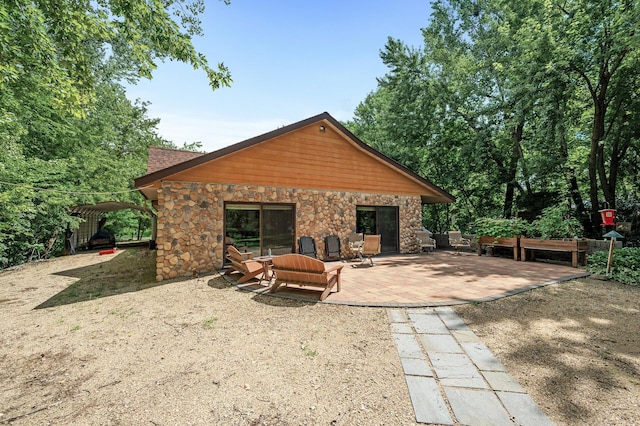 rear view of property featuring a patio area