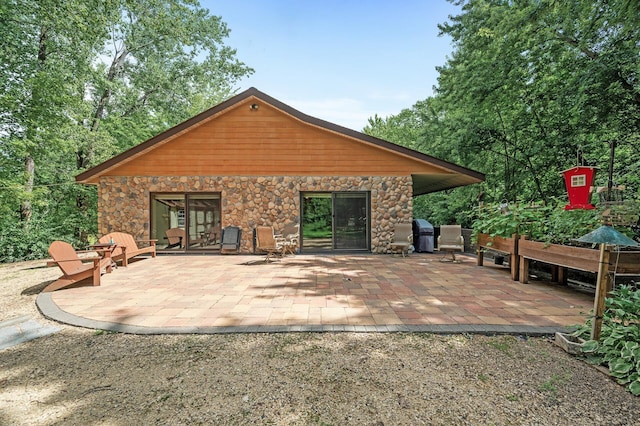 rear view of property featuring a patio area