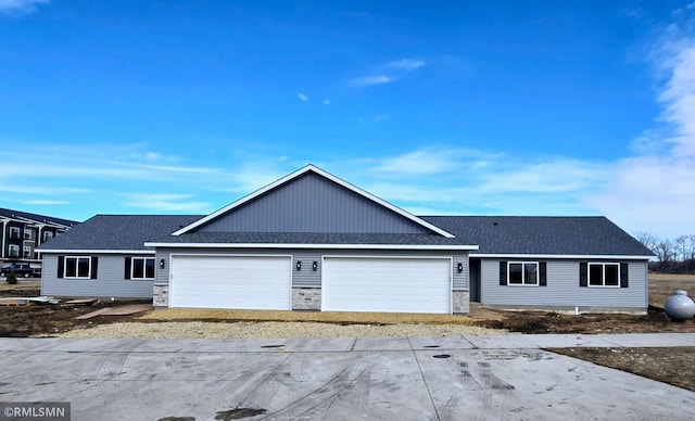 ranch-style house featuring a garage, stone siding, and a shingled roof