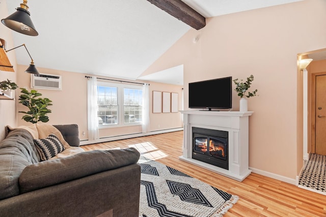 living area featuring beam ceiling, a baseboard heating unit, a glass covered fireplace, light wood-type flooring, and a wall mounted air conditioner