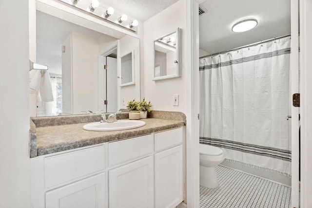 bathroom featuring tile patterned flooring, a shower with shower curtain, vanity, and toilet