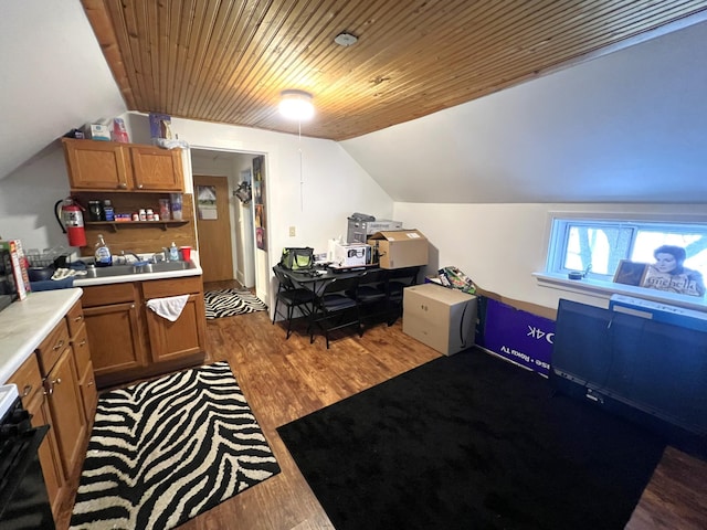 kitchen with lofted ceiling, sink, wooden ceiling, hardwood / wood-style flooring, and stove