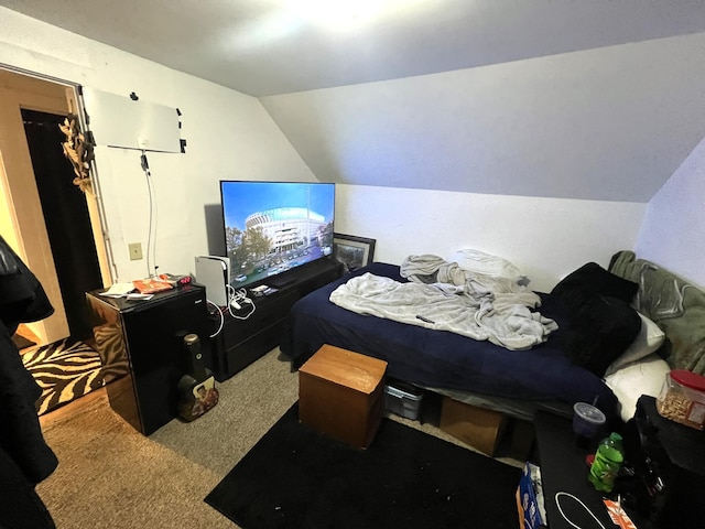 bedroom featuring lofted ceiling and carpet floors