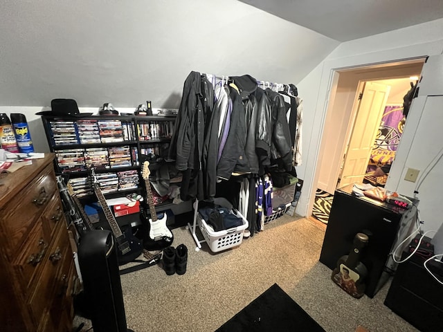 walk in closet with vaulted ceiling and carpet floors