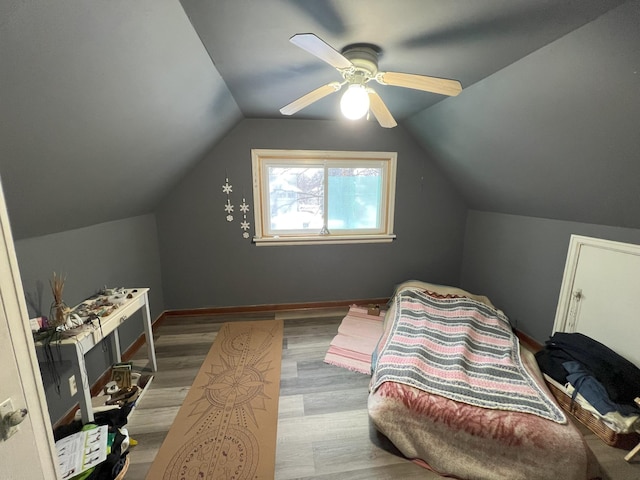 bedroom featuring lofted ceiling, ceiling fan, and light hardwood / wood-style flooring