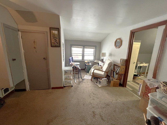 carpeted living room with vaulted ceiling