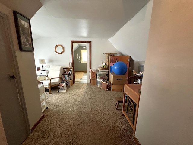 bonus room with lofted ceiling and carpet flooring