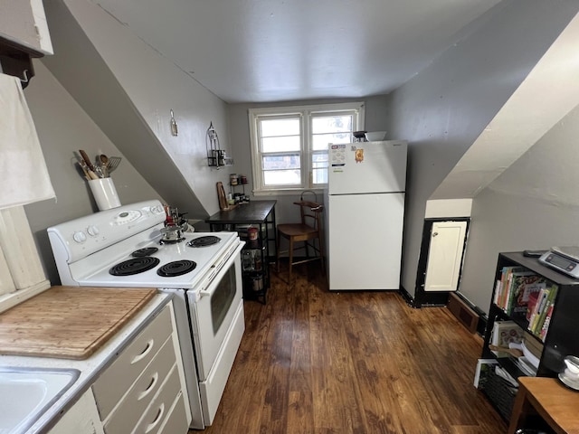 kitchen featuring white cabinetry, dark hardwood / wood-style flooring, and white appliances