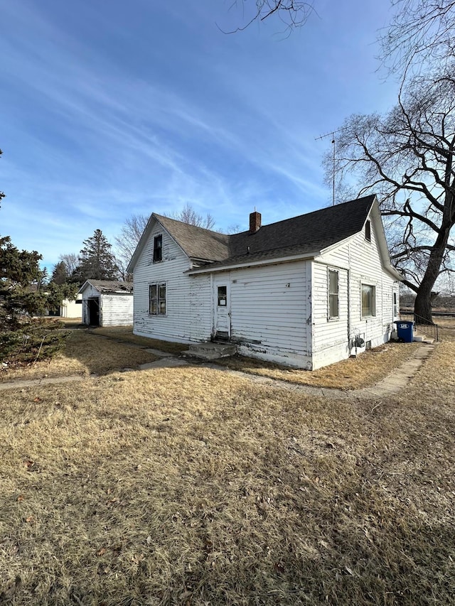 rear view of property with a chimney