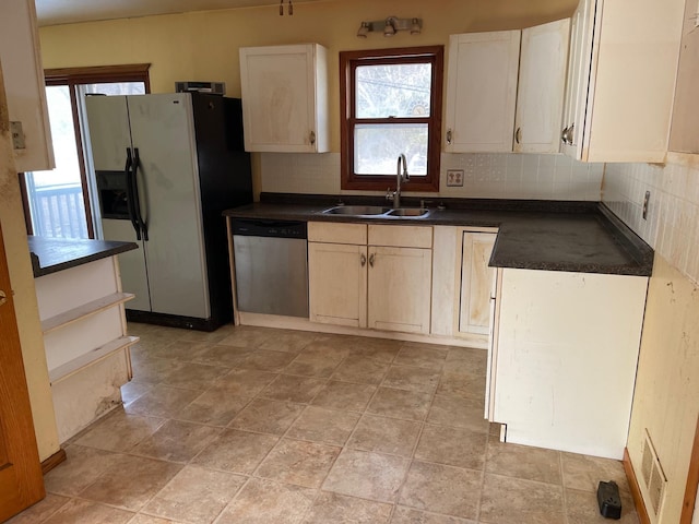 kitchen featuring tasteful backsplash, sink, and appliances with stainless steel finishes