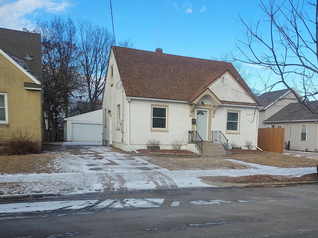 view of front facade with a garage and an outdoor structure