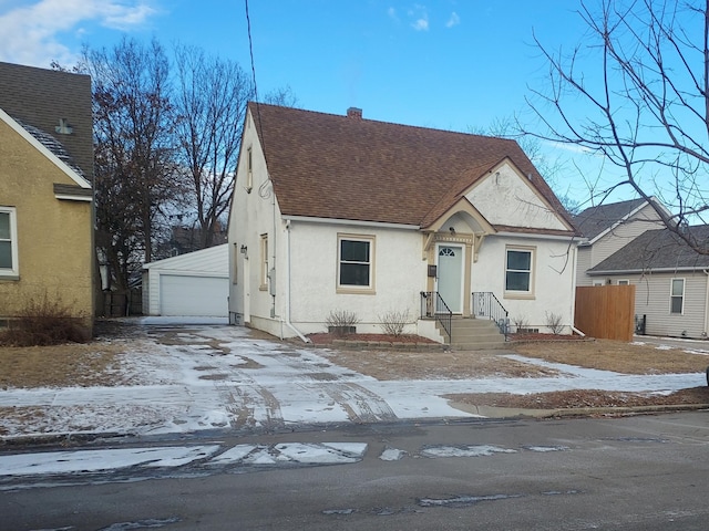 view of front facade with a garage and an outdoor structure