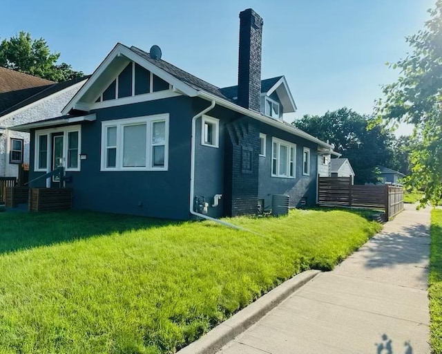 view of home's exterior featuring a yard and central AC unit