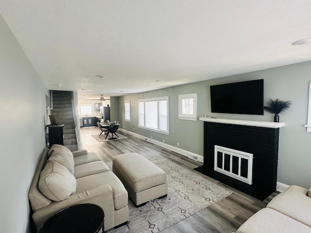 living room featuring wood-type flooring and a textured ceiling