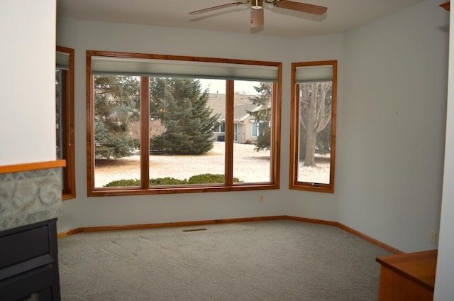 spare room featuring carpet and ceiling fan