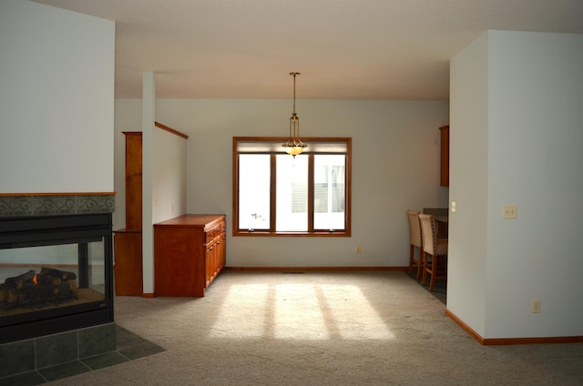 carpeted living room with a tile fireplace