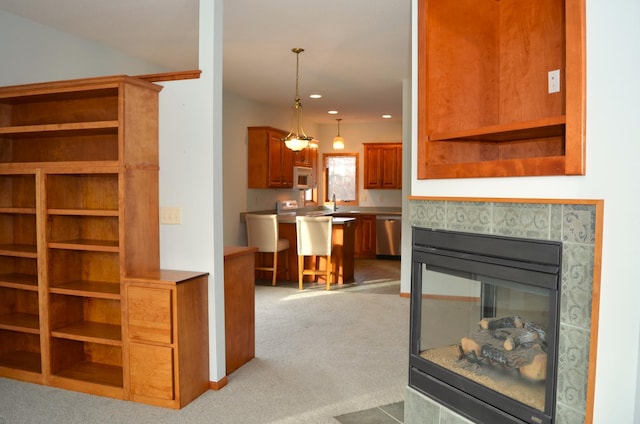 carpeted living room with a tile fireplace