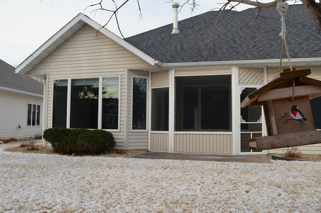 back of house featuring a sunroom