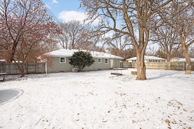 yard layered in snow with central AC