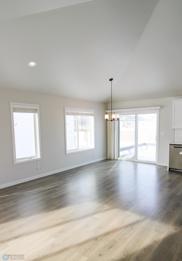 unfurnished living room featuring hardwood / wood-style flooring and a notable chandelier