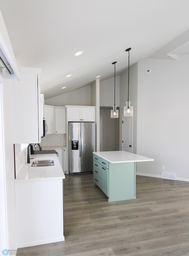 kitchen with sink, stainless steel appliances, a center island, and white cabinets