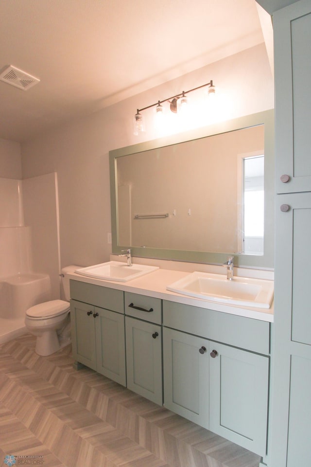 bathroom featuring vanity and toilet