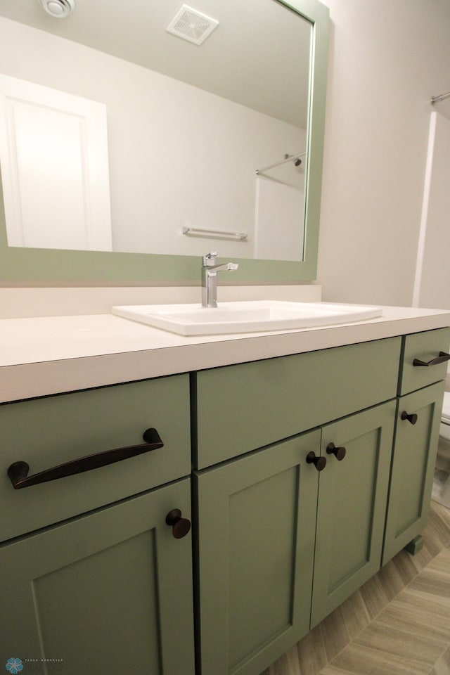 bathroom featuring vanity, a shower, and toilet