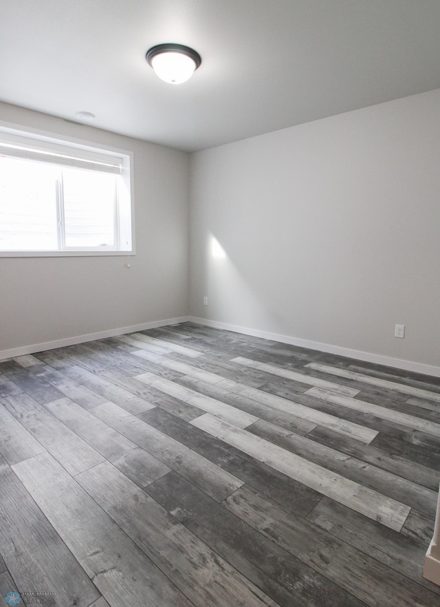 unfurnished room featuring dark hardwood / wood-style flooring