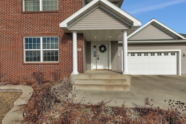 exterior space with concrete driveway, brick siding, and an attached garage