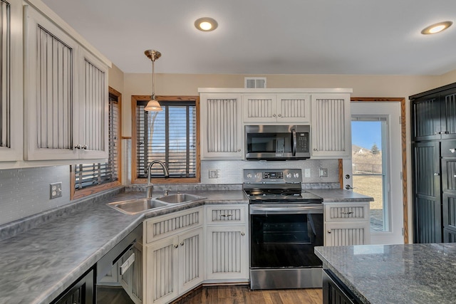 kitchen with a healthy amount of sunlight, visible vents, appliances with stainless steel finishes, and a sink