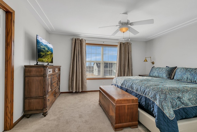 bedroom featuring baseboards, a ceiling fan, and light colored carpet