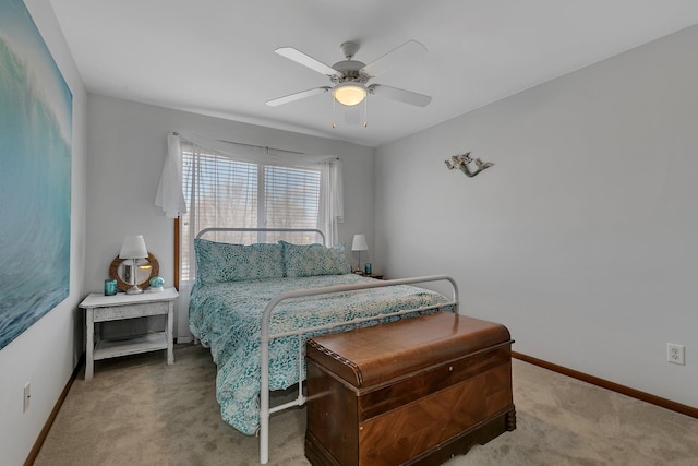 carpeted bedroom with a ceiling fan and baseboards