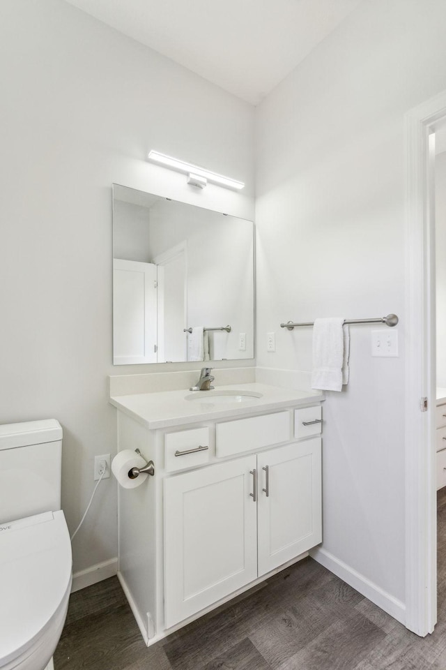 18338 Dove Ct, Eden Prairie, MN 55347 - bathroom with hardwood / wood-style flooring, vanity, and toilet