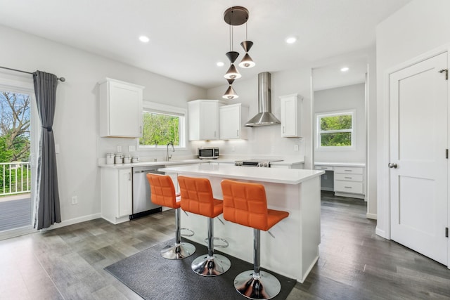 18338 Dove Ct, Eden Prairie, MN 55347 - kitchen with white cabinetry, stainless steel appliances, wall chimney exhaust hood, and a kitchen island