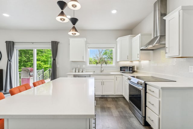 18338 Dove Ct, Eden Prairie, MN 55347 - kitchen featuring sink, white cabinetry, pendant lighting, stainless steel appliances, and wall chimney range hood