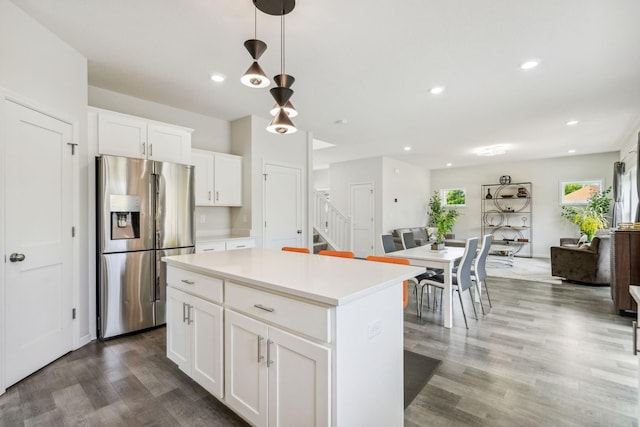 18338 Dove Ct, Eden Prairie, MN 55347 - kitchen featuring dark wood-type flooring, stainless steel fridge, hanging light fixtures, a center island, and white cabinets