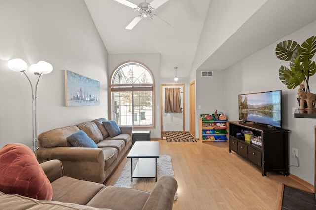 living room with ceiling fan, high vaulted ceiling, and light wood-type flooring