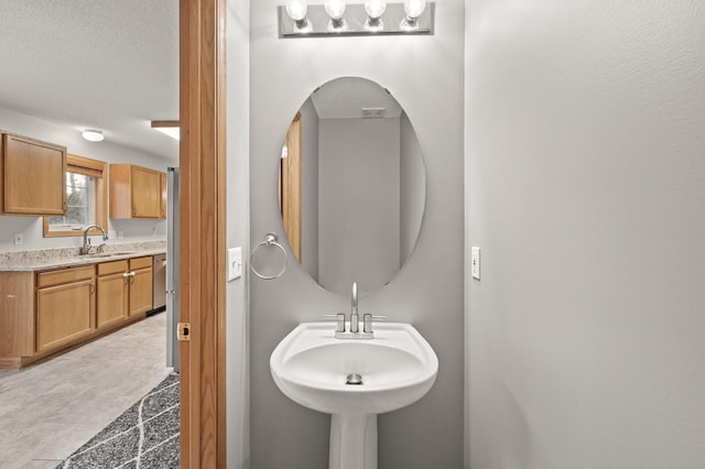 bathroom featuring sink and a textured ceiling