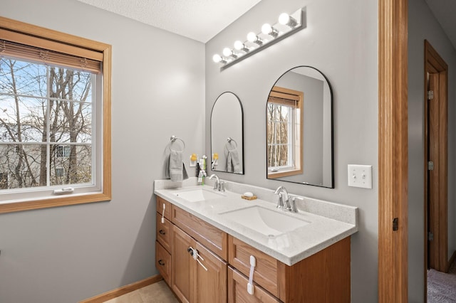 bathroom with vanity, plenty of natural light, and a textured ceiling