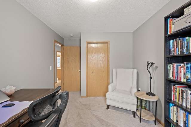 office space featuring light colored carpet and a textured ceiling