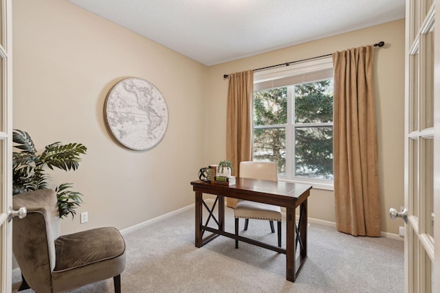 carpeted home office featuring french doors