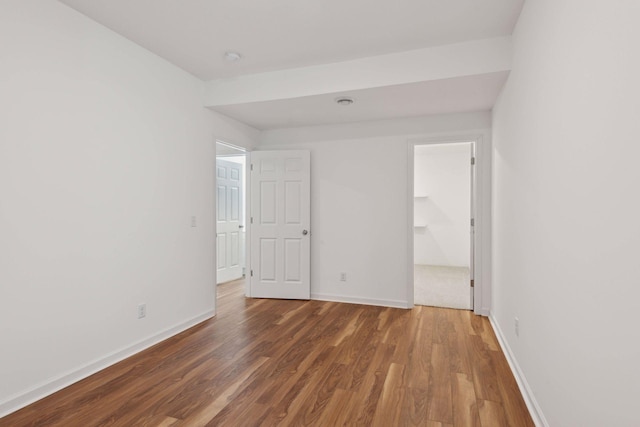 spare room featuring dark wood-type flooring