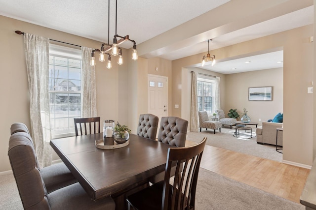 dining space featuring a textured ceiling and light wood-type flooring