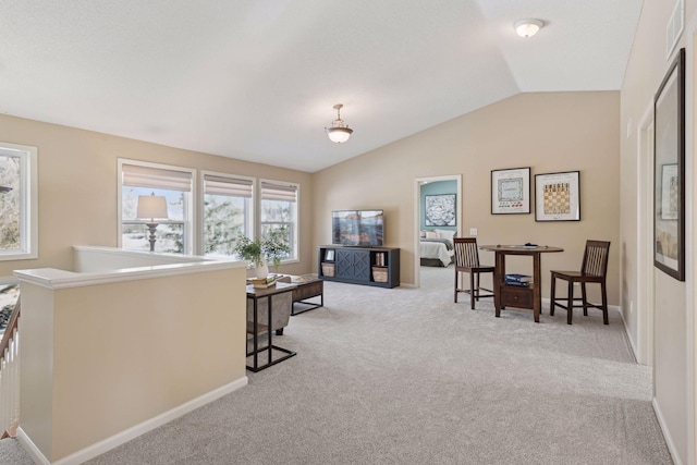 living room with lofted ceiling and light colored carpet